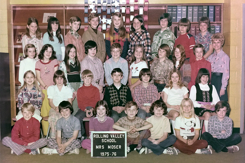 Color class photograph showing Mrs. Moser's classroom during the 1975 to 1976 school year. The grade level of the class is not stated, but it appears to be either a 5th or 6th grade classroom based on the age of the children. Mrs. Moser can be seen on the far right. There are 32 children pictured, an even mix of girls and boys. 